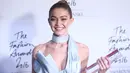 Senyum Gigi Hadid saat berpose sambil memegang trofi penghargaan International Model of the Year dalam acara Fashion Awards di London, Senin (5/12). Gigi berhasil mengalahkan adiknya sendiri, Bella hadid dan sahabatnya Kendal Jenner. (REUTERS/Neil Hall)