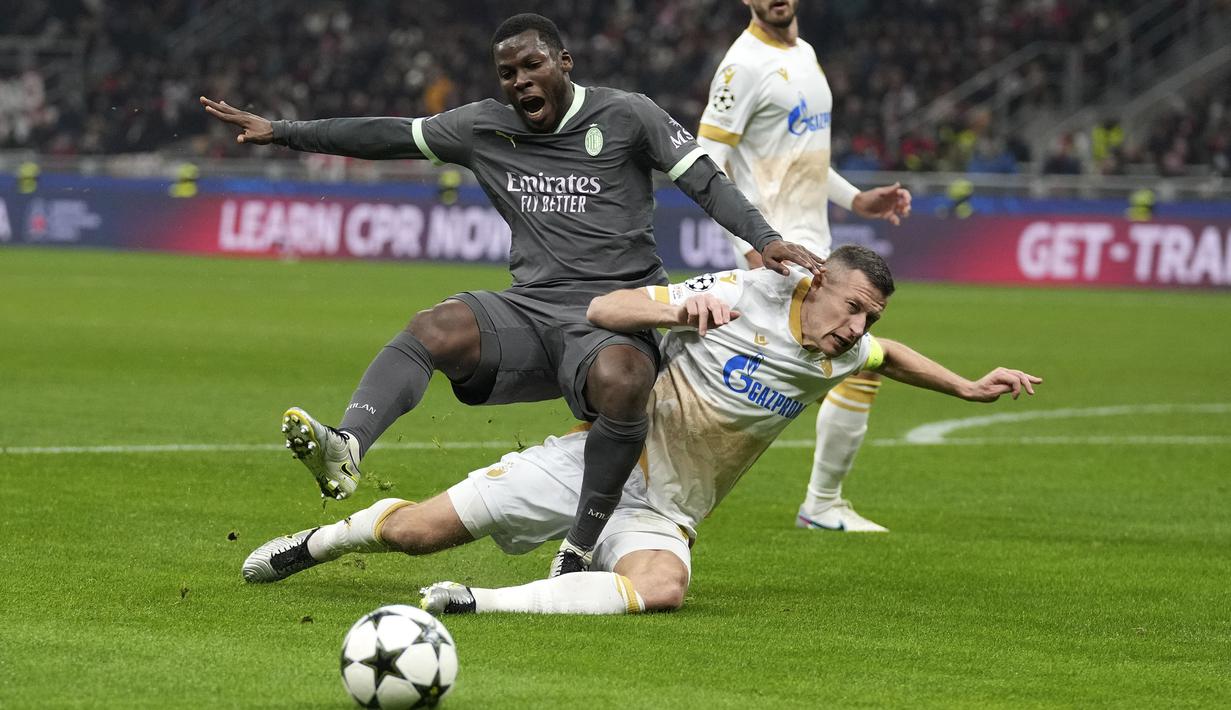 Pemain AC Milan, Yunus Musah berebut bola dengan pemain Red Star Belgrade, Uros Spajic pada laga Liga Champions 2024/2025 di San Siro, Milan, Italia, Kamis (12/12/2024) WIB. (AP Photo/Antonio Calanni)