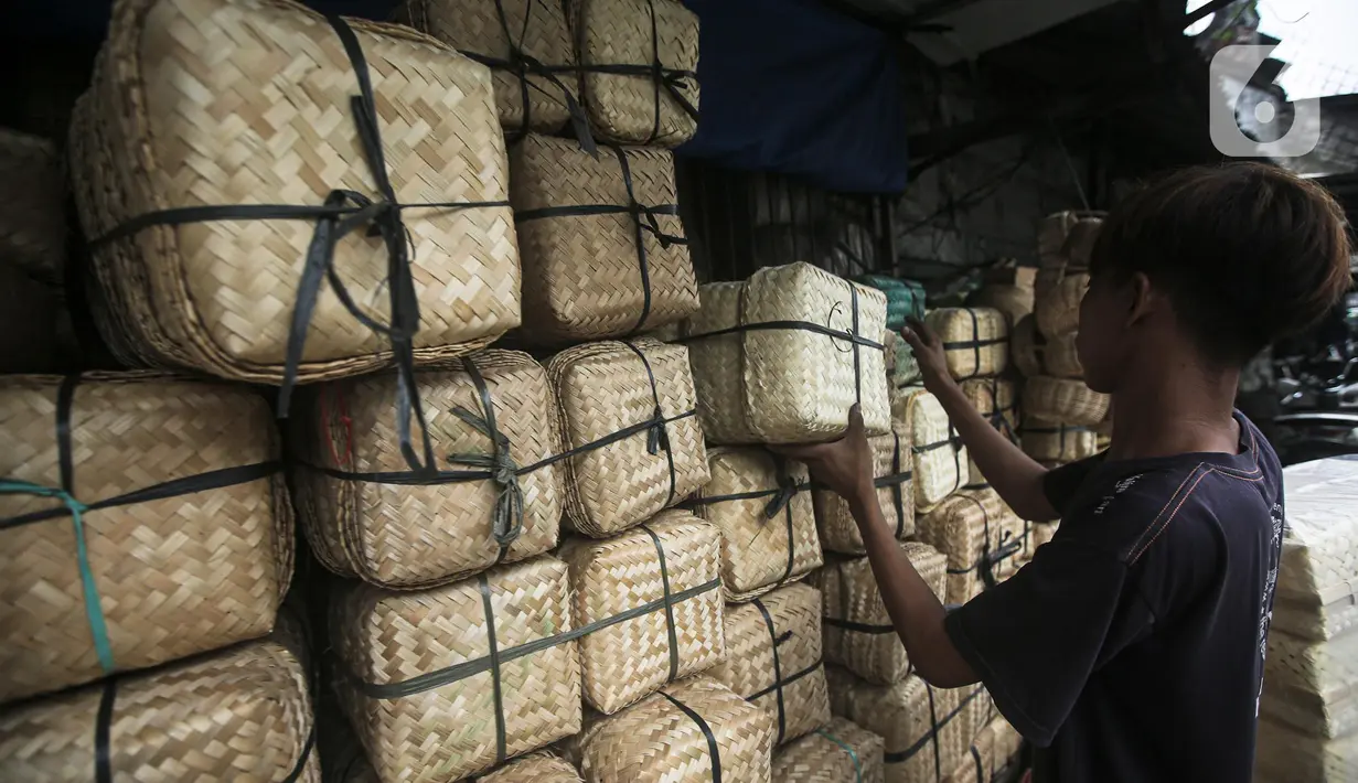 Pedagang menata wadah besek bambu di Kawasan Jatinegara, Jakarta, Rabu (6/7/2022). Jelang Idul Adha, penjualan besek untuk tempat daging kurban yang ramah lingkungan mengalami peningkatan. (Liputan6.com/Faizal Fanani)