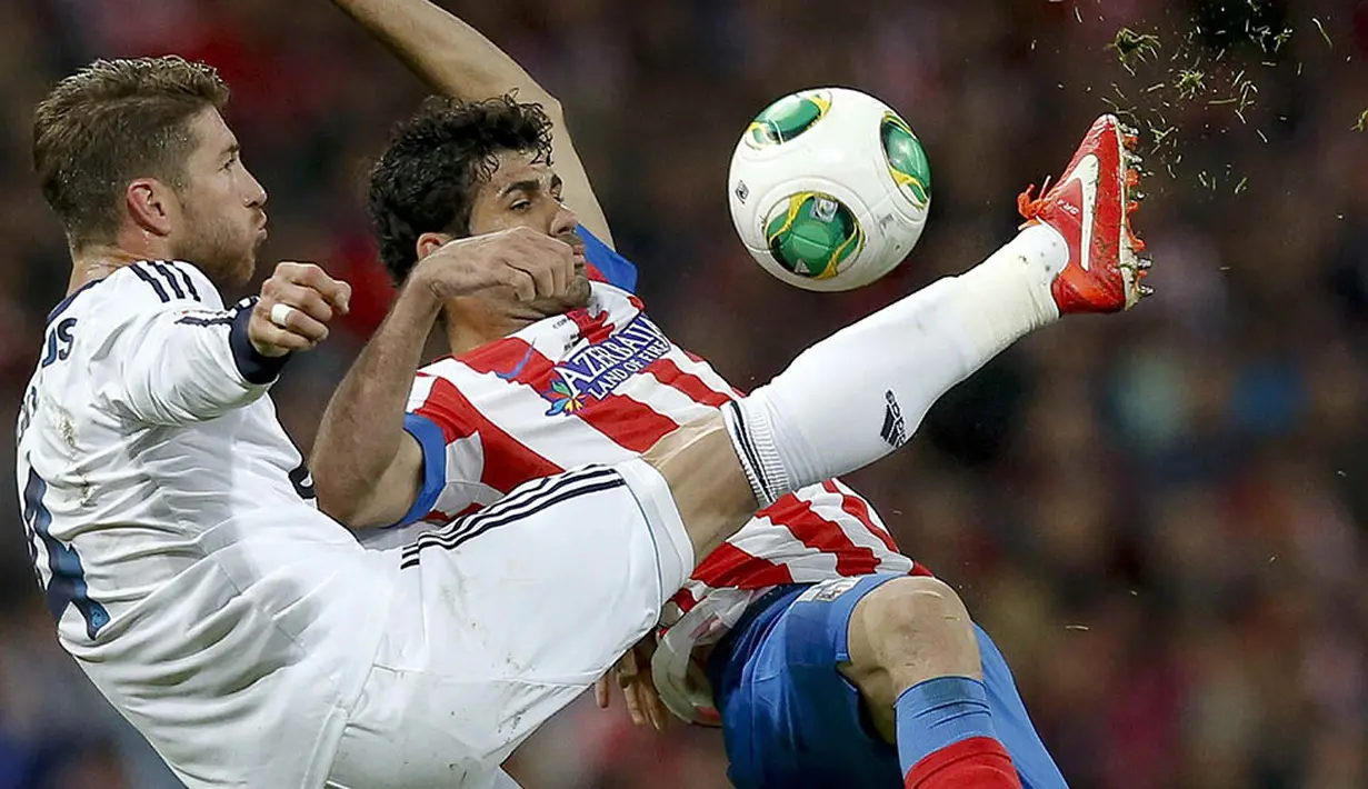 Striker Atletico Madrid, Diego Costa, berebut bola dengan bek Real Madrid, Sergio Ramos, pada laga final Piala Raja di Stadion Santiago Bernabeu, Spanyol, Jumat (17/5/2013). (EPA/Alberto Martin)