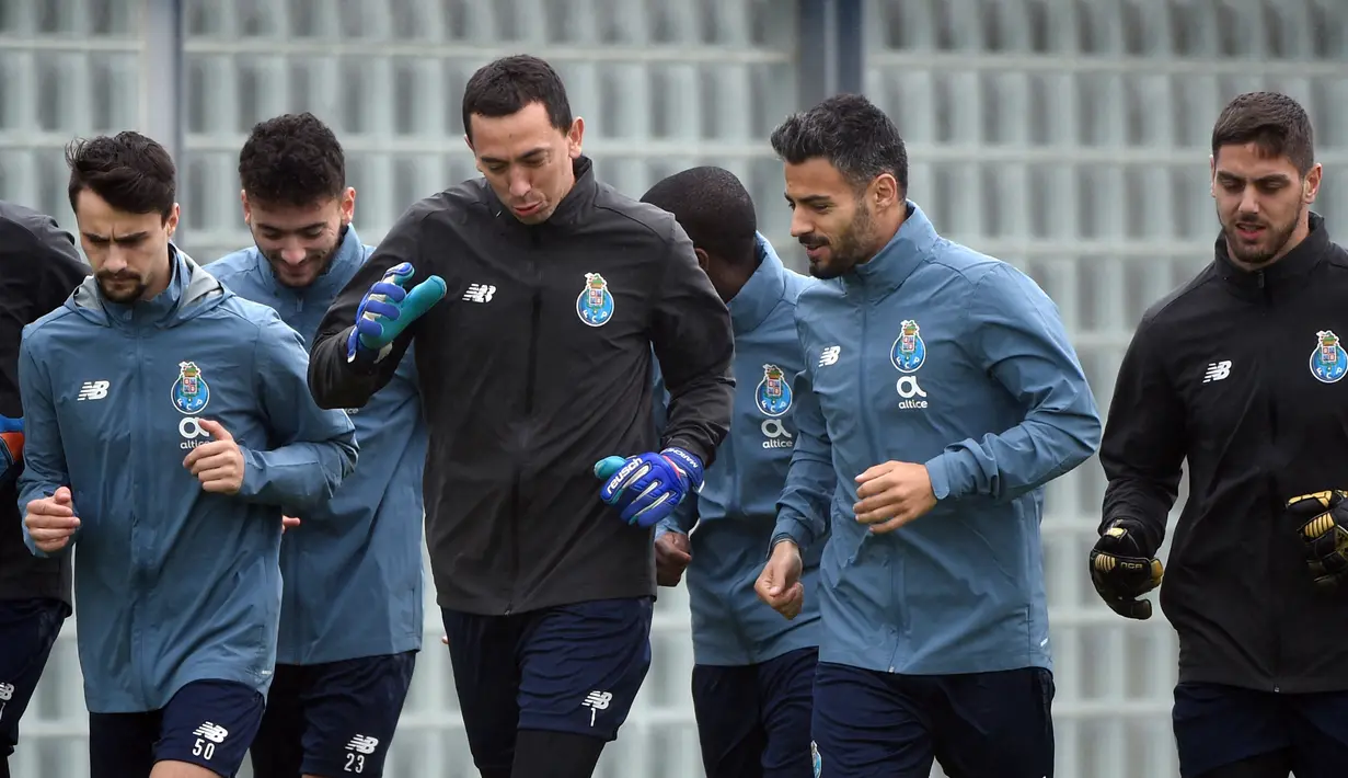 Penjaga gawang FC Porto Agustin Marchesin (tengah) melakukan pemanasan bersama rekan satu tim selama sesi latihan di tempat latihan Olival di Vila Nova de Gaia (16/2/2021). Porto merupakan penghuni peringkat kedua Grup C Liga Champions. (AFP/Miguel Riopa)