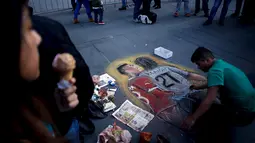 Seniman Chili melukis tindakan provokasi Gonzalo Jara terhadap pemain Uruguay, Edinson Cavani di trotoar jalan di Santiago, Chili (28/6/2015). Akibat aksinya Jara didenda 7.500 dollar Amerika Serikat atau sekitar Rp 100 juta. (REUTERS/Marcos Brindicci)