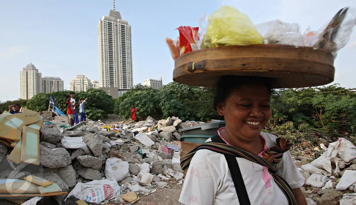 Seorang pedagang melintasi kawasan limbah bangunan yang digunakan Anak-anak bermain layang-layang di Gandaria, Jakarta, Jumat (4/3). (Liputan.com/Immanuel Antonius)