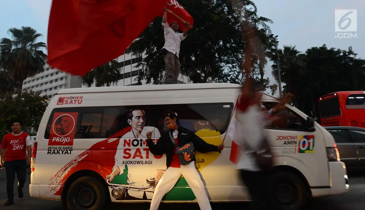 Pendukung capres-cawapres 01 Jokowi-Ma'ruf Amin berkeliling di kawasan Bundaran HI, Jakarta, Rabu (17/4). Berdasarkan hasil hitung cepat  Pasangan Jokowi-Ma'ruf Amin unggul diberbagai lembaga survei. (Merdeka.com/Imam Buhori)