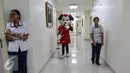 Seorang boneka Minie Mouse bersama perawat berjalan di lorong usai menghibur pasien anak di Rumah Sakit Siloam Karawaci, Tangerang, Sabtu (23/7). Moment tersebut untuk memberi rasa nyaman bagi pasien anak yang sedang berobat. (Liputan6.com/Fery Pradolo)