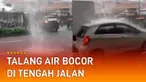 Terlihat talang air bocor hingga membuat air mengucur deras di tengah jalan.
