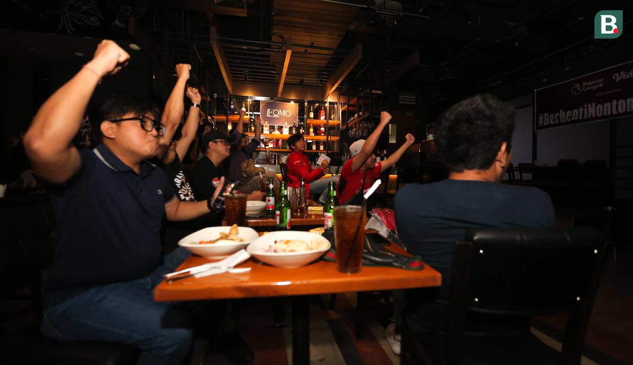 Pendukung Manchester United merayakan gol yang dicetak oleh Alejandro Garnacho ke gawang West Ham saat acara Roaring Night yang berlangsung di Fomo Bar, Melawai, Jakarta, Minggu (04/02/2024) malam WIB. (Bola.com/Bagaskara Lazuardi)