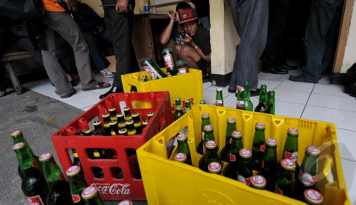 Tampak minuman keras berhasil disita petugas kepolisian di kawasan terminal Pulogadung, Jakarta, Kamis, (12/3/2015). Petugas berhasil menyita minuman keras, senjata tajam, dan belasan orang yang diduga preman di lokasi tersebut. (Liputan6.com/Johan Tallo)