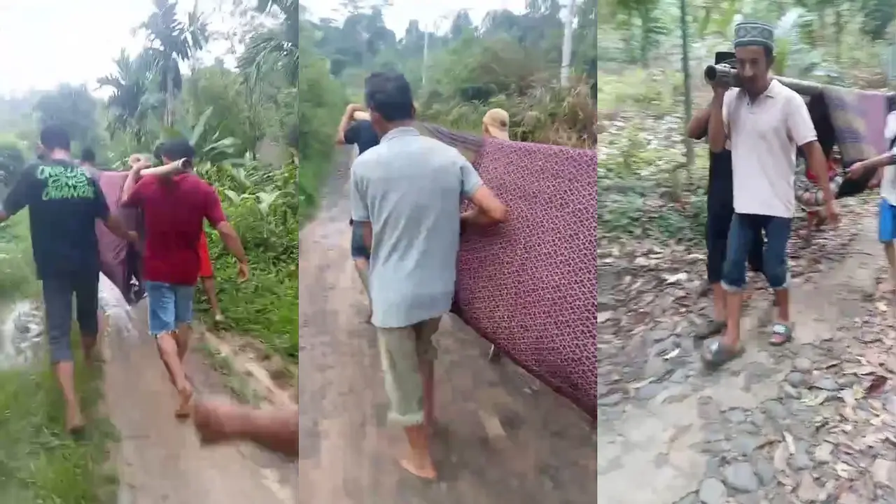Sebuah video warga Tanggamus, Lampung, yang bergotong royong menggotong jenazah dengan sarung dan bambu untuk dikebumikan, lantaran akses jalan yang rusak. (Istimewa)