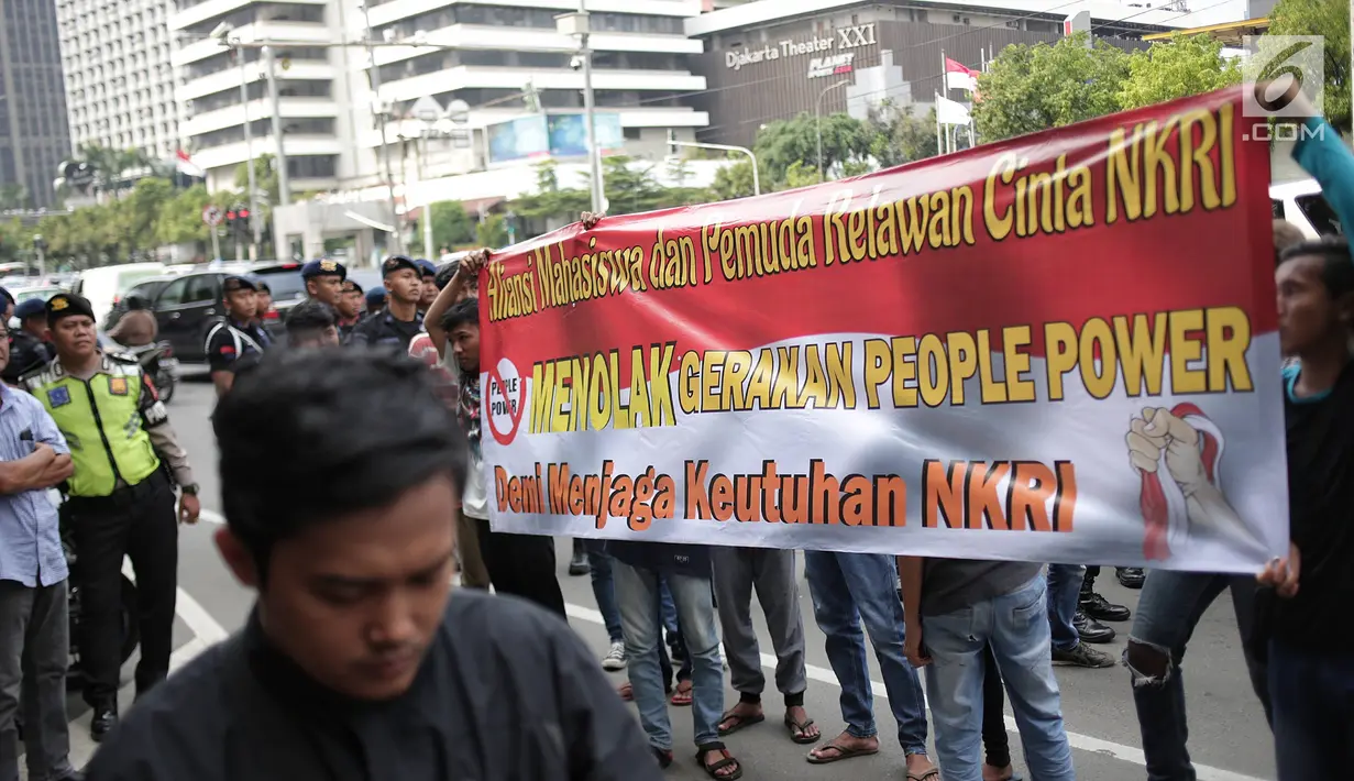 Massa yang tergabung dalam aliansi mahasiswa dan pemuda relawan cinta NKRI membawa spanduk saat unjuk rasa di depan Gedung Bawaslu, Jakarta, Jumat (17/5). Dalam aksinya mereka menolak Gerakan People Power karena syarat dengan kepentingan politik inkonstitusional. (Liputan6.com/Faizal Fanani)