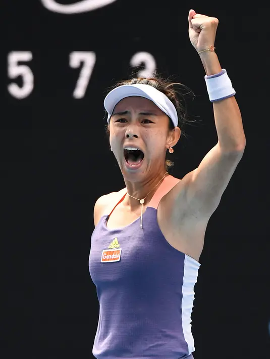 Petenis China, Wang Qiang merayakan kemenangan setelah mengalahkan Serena Williams dari AS dalam pertandingan tunggal putri hari kelima turnamen tenis Australia Terbuka 2020 di Melbourne (24/1/2020). (AFP Photo/William West)