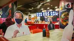 Banner bergambar karakter Presiden Joko Widodo terlihat di sebuah Restoran Hulu Hulu, Mall Kuningan City, Jakarta, Senin (1/3/2021). Banner bergambar tersebut berguna untuk pembatas bagi pengunjung yang makan di tempat saat pandemi.(Liputan6.com/Faizal Fanani)
 
