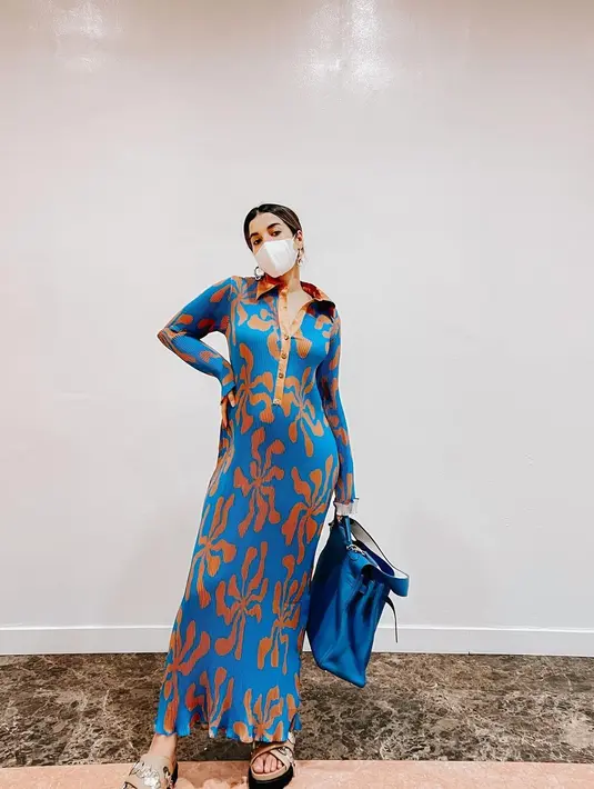 Keseruan tampilan lain yang dihadirkan kala ia mengenakan printed dress. Motif bunga dengan nuansa kontras berpotongan fit dengan tubuh menampilkan baby bump-nya yang tampak kian menggemaskan.