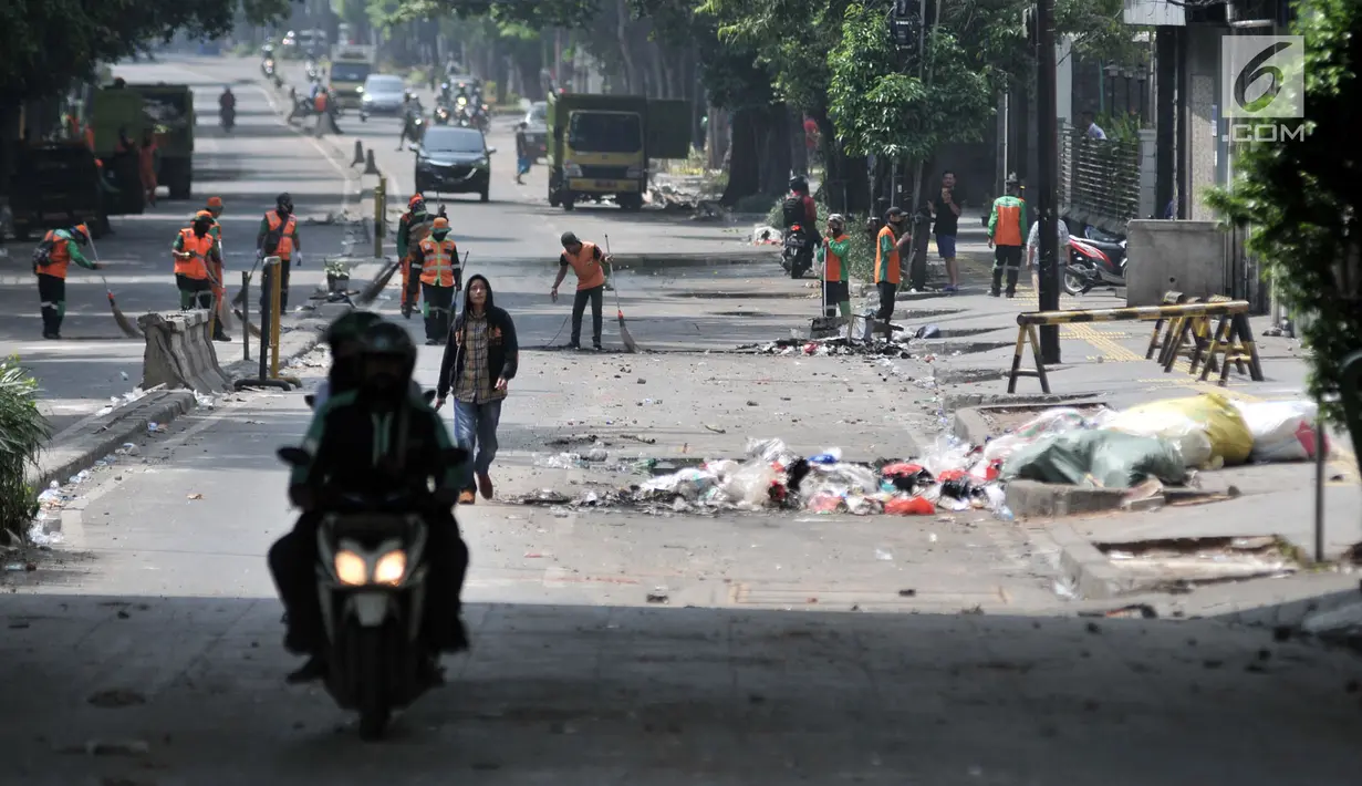 Petugas PPSU membersihkan puing-puing sampah yang ditimbulkan akibat ricuh pendemo di sekitar pasarTanah Abang, Jakarta, Rabu (22/5/2019). Tak ada aktivitas perdagangan pagi ini di Pasar Tanah Abang, menyusul aksi 22 Mei 2019. (merdeka.com/Iqbal S Nugroho)