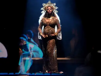 Penyanyi Beyonce memberikan penampilan memukau di atas panggung Grammy Awards 2017 di Staples Center, Los Angeles, Minggu (12/2). Di acara penghargaan itu, Beyonce terlihat megah bak dewi dengan kostum serba emas. (Kevin Winter/Getty Images for NARAS/AFP)