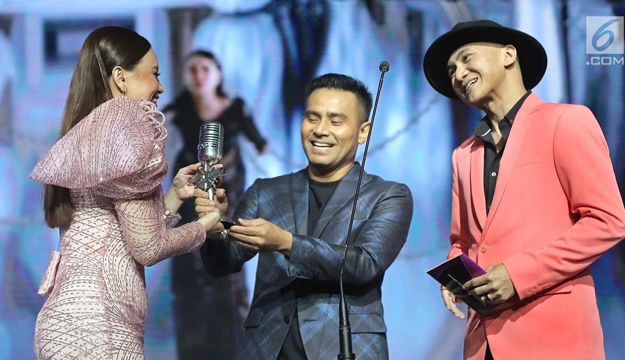 Penyanyi Rossa (kiri) menerima penghargaan dalam ajang musik SCTV Music Awards 2019 di Studio 6 Emtek City, Jakarta, Jumat (26/4). Rossa menyabet piala penghargaan Penyanyi Solo Wanita Paling Ngetop mengungguli Bunga Citra Lestari, Isyana Sarasvati, Maudy Ayunda dan Raisa (Fimela.com/Bambang E. Ros)