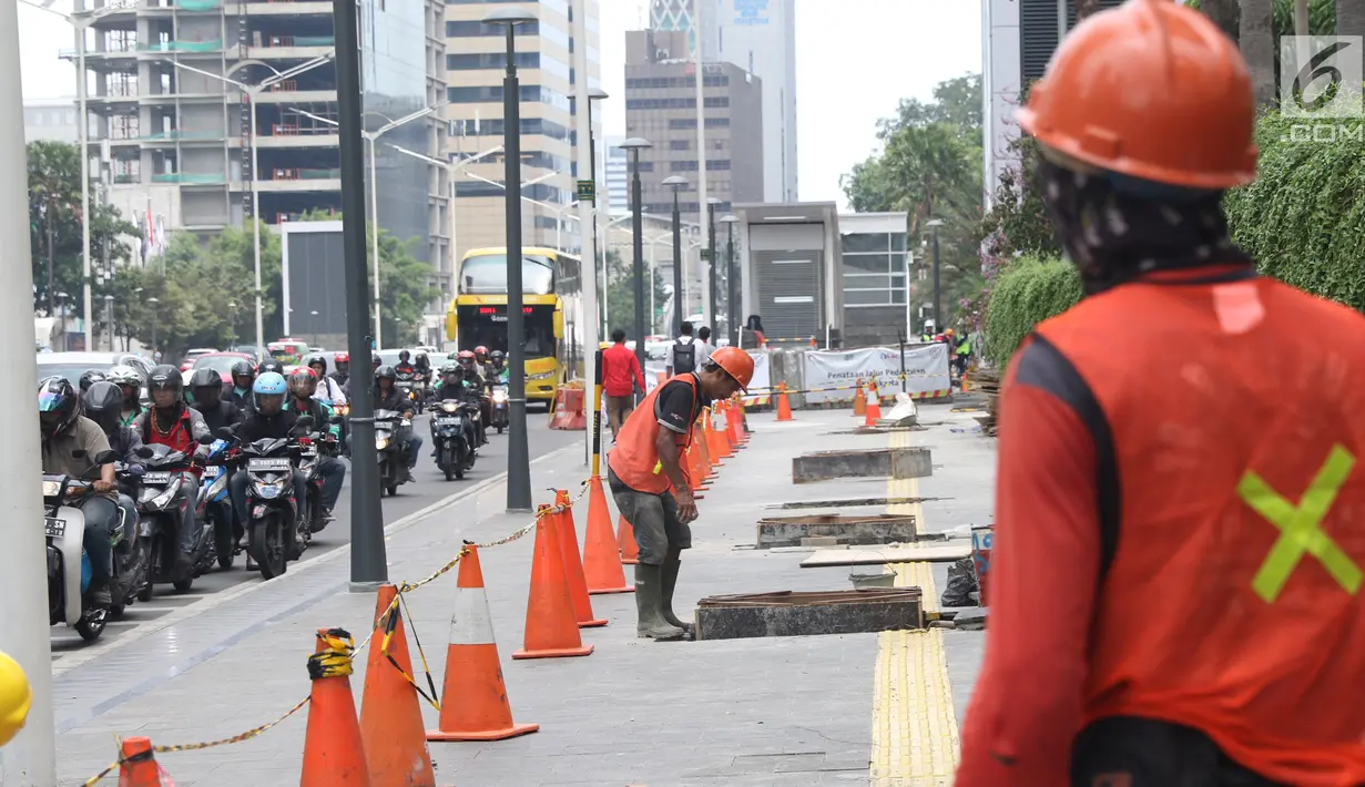 Pekerja tengah mengerjakan peremajaan gorong-gorong di kawasan Thamrin, Jakarta, Selasa (15/1).Peremajaan dilakukan untuk mengantisipasi terjadinya penyumbatan saluran yang dapat menyebabkan banjir di kawasan tersebut. (Liputan6.com/Angga Yuniar)