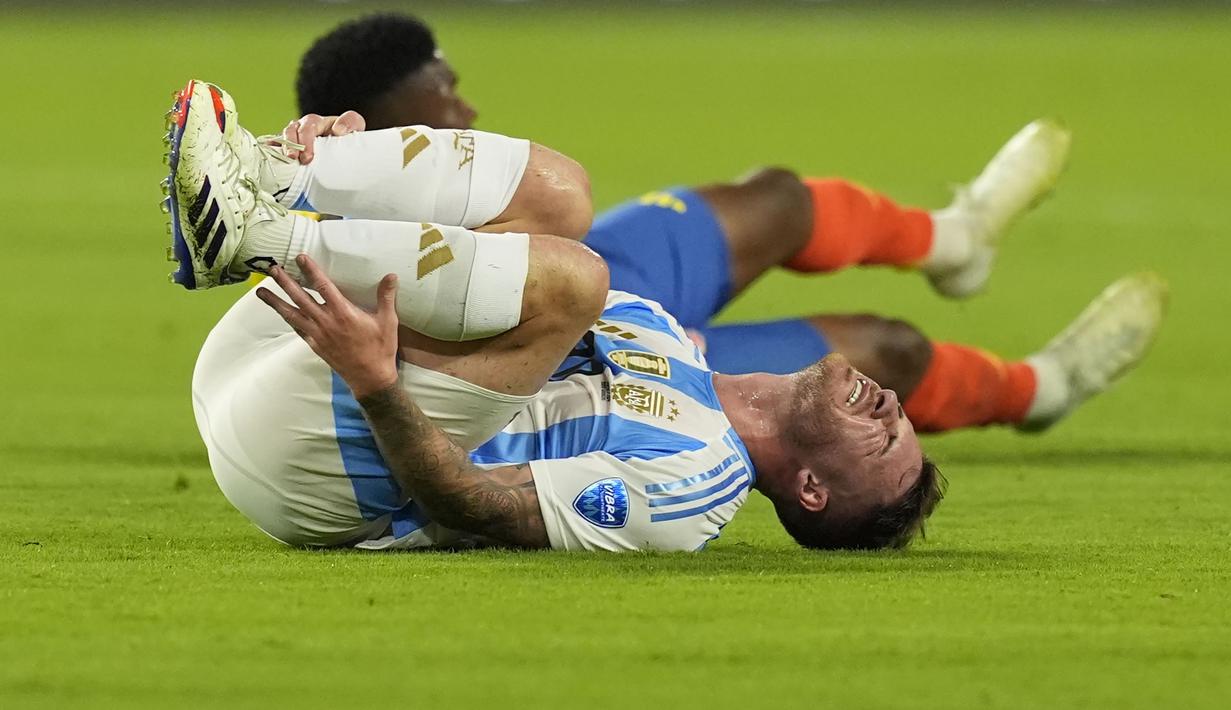 Gelandang Timnas Argentina, Alexis Mac Allister mengerang kesakitan usai berbenturan dengan seorang pemain Timnas Kolombia pada laga final Copa America 2024 di Hard Rock Stadium, Florida, Amerika Serikat, Minggu (14/7/2024). (AP Photo/Rebecca Blackwell)