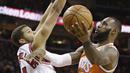 Bintang Cleveland Cavaliers, LeBron James (kanan) melakukan layup melewati hadangan pemain Chicago Bulls, Michael Carter-Williams pada aga NBA basketball game di Quicken Loans Arena, Cleveland. (AP/Tony Dejak)