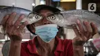 Pedagang menunjukan ikan bandeng di Pasar Petak Sembilan, Glodok, Jakarta, Senin (31/1/2022). Ikan bandeng banyak dibeli jelang Imlek sebagai hidangan saat perayaan Tahun Baru masyarakat Tionghoa itu. (Liputan6.com/Faizal Fanani)