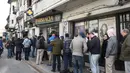 Orang-orang berbaris mengantre di depan apotek untuk membeli ganja di Montevideo, Uruguay (19/7 Apotek ini menjual ganja tersebut seharga USD 6,5 atau berkisar Rp 86.000 per lima gram. (AFP Photo/Miguel Rojo)