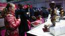 Seorang pengunjung melihat "Manneken Pis" yang terbuat dari cokelat di Pameran Cokelat Brussel ketujuh di Brussel, Belgia (13/2/2020). (Xinhua/Zhang Cheng)