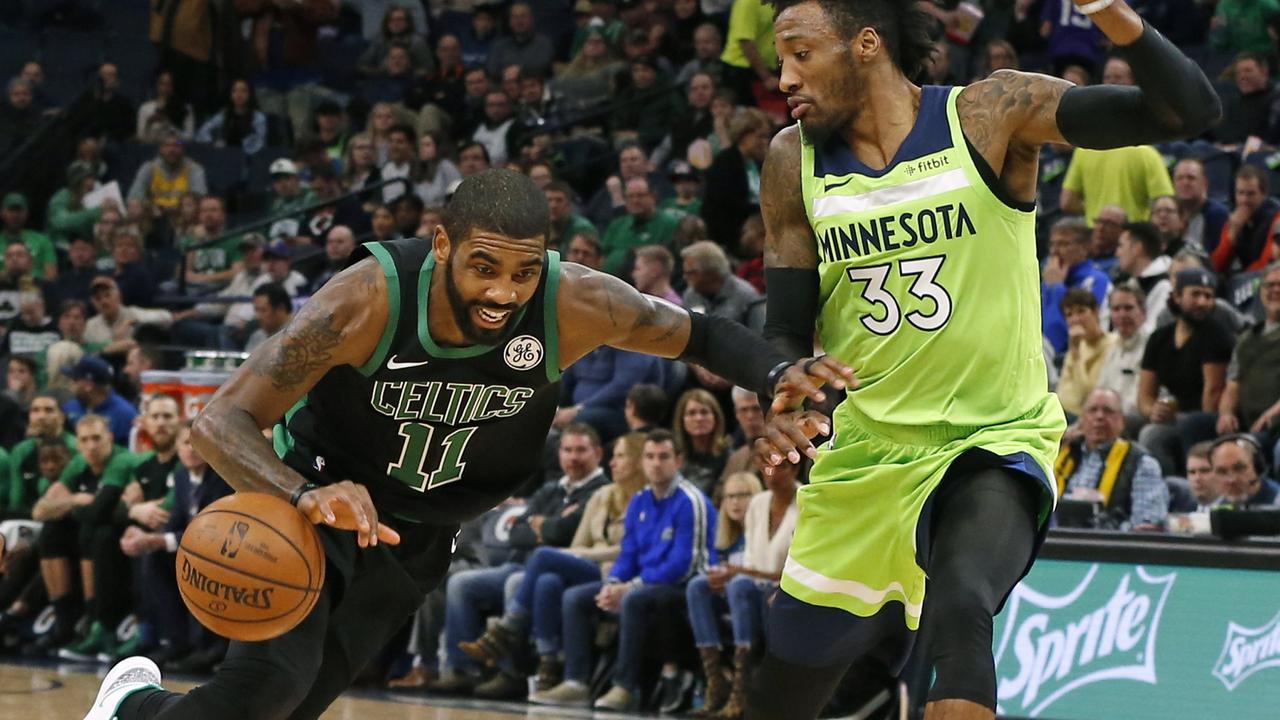 Point guard Celtics Kyrie Irving menerobos pertahanan Timberwolves di laga NBA