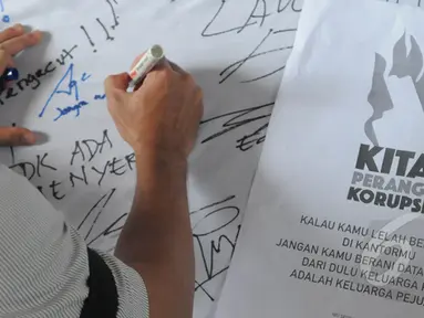 Pegawai KPK menandatangani dukungan unjuk rasa di halaman gedung KPK, Jakarta, Selasa (3/3/2015). Dalam aksinya, pegawai KPK menolak putusan Plt Pimpinan KPK yang melimpahkan kasus Komjen Pol Budi Gunawan ke Kejaksaan Agung. (Liputan6.com/Herman Zakharia)