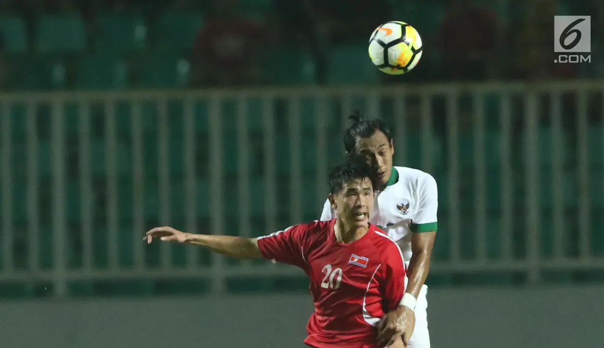Bek Indonesia U-23, Hansamu Yama Pranata (kanan) berebut bola atas dengan pemain Korea Utara, So Jong Hyok pada laga PSSI Anniversary Cup 2018 di Stadion Pakansari, Kab Bogor, Senin (30/4). Babak pertama imbang 0-0. (Liputan6.com/Helmi Fithriansyah)