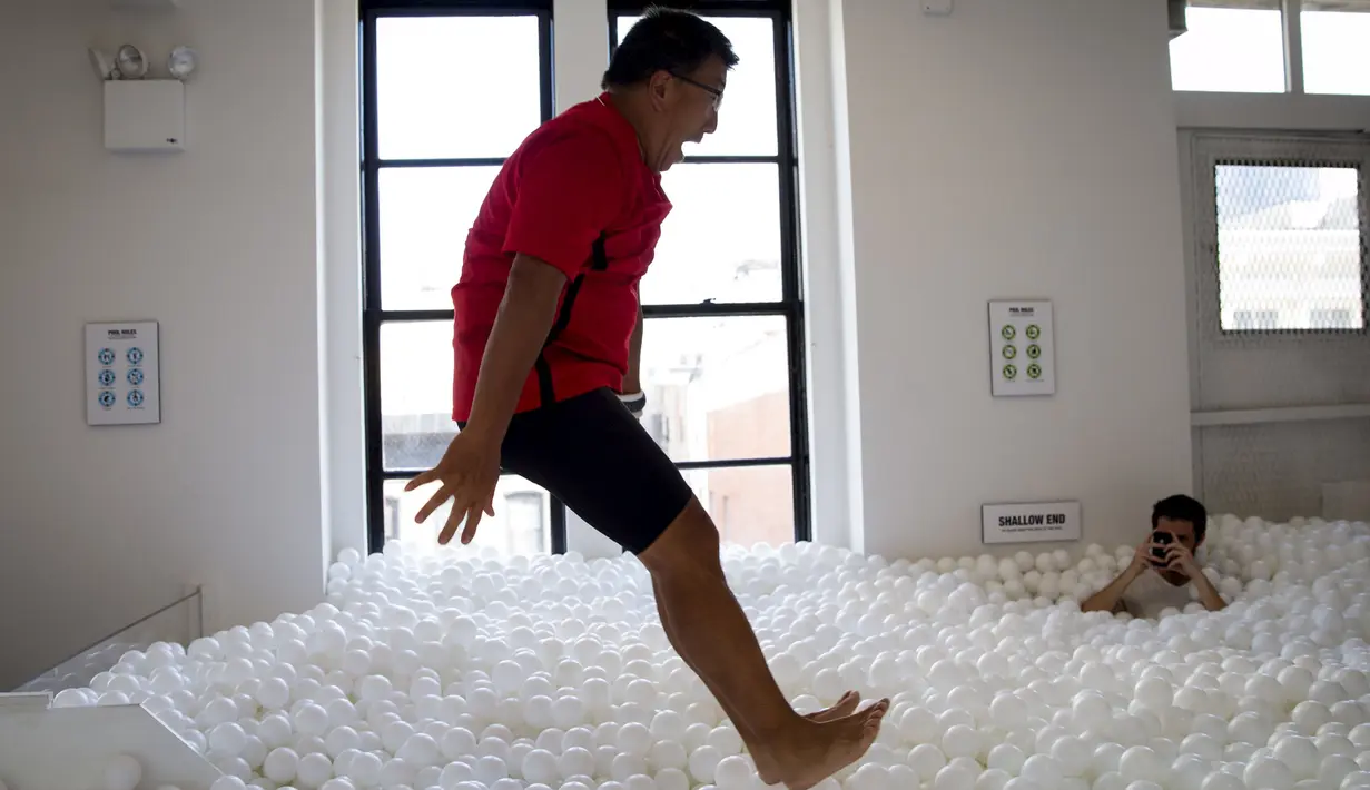  Seorang Pria melompat kedalam kolam bola di kantor SoHo, New York City, Selasa (25/8/2015). Tempat ini juga dibuka untuk umum dari 21 Agustus sampai 21 September. (REUTERS/Mike Segar)
