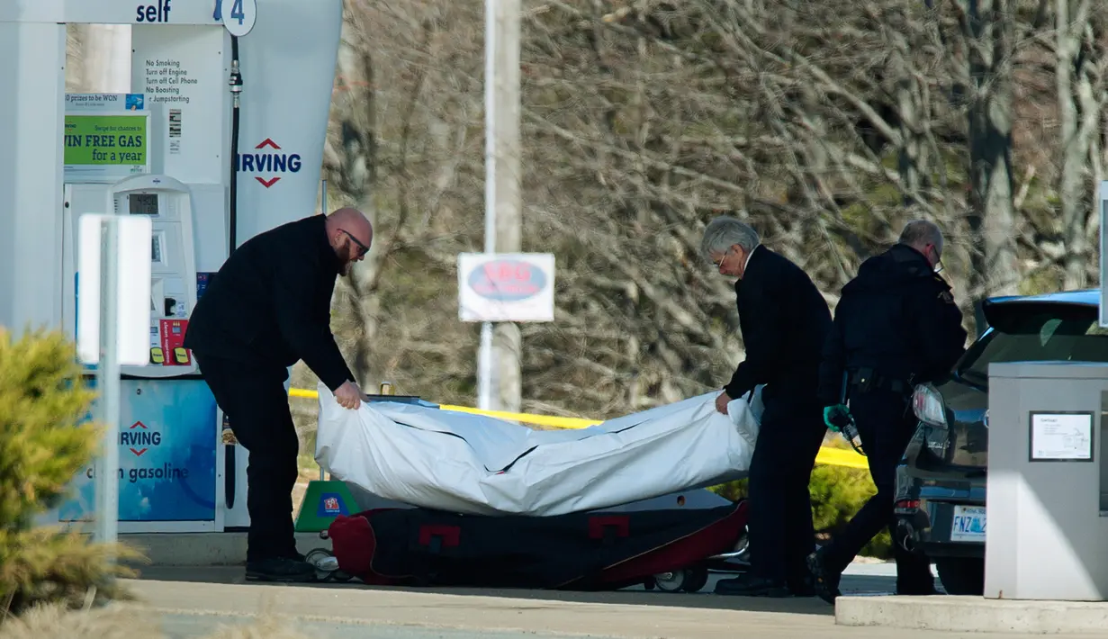 Petugas medis mengevakuasi korban penembakan di sebuah pom bensin di Enfield, Nova Scotia, Minggu (19/4/2020). Aksi itu ia lancarkan dalam kurun waktu selama 12 jam, lapor pihak berwenang. (Tim Krochak/The Canadian Press via AP)