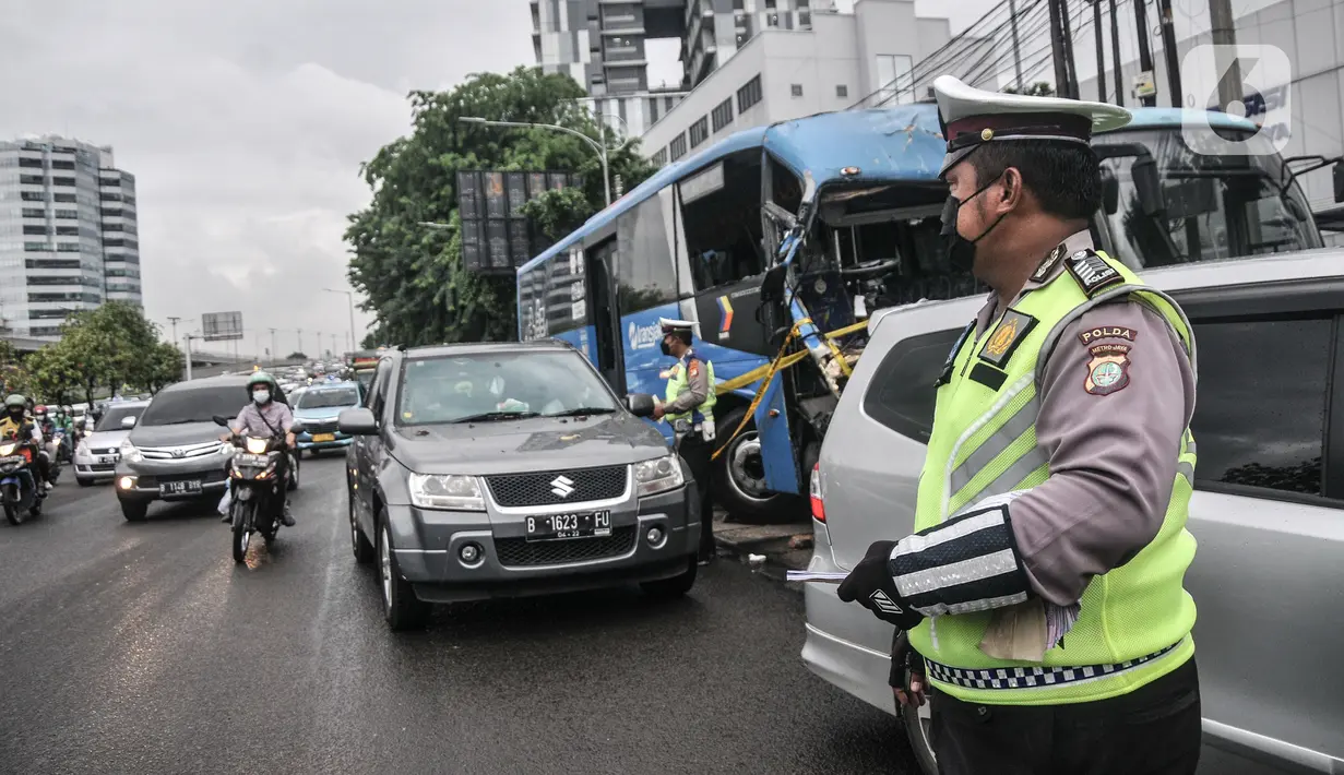 Petugas kepolisian menilang pengendara mobil yang melanggar aturan ganjil genap di Jalan MT Haryono, Jakarta, Kamis (28/10/2021). Para pelanggar sistem ganjil genap dikenakan sanksi tilang berupa denda maksimal Rp500 ribu. (merdeka.com/Iqbal S Nugroho)