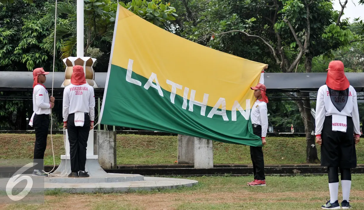 Anggota Paskibraka berlatih mengibarkan bendera di Lapangan PP PON Cibubur, Jakarta, Kamis (11/8). Mereka adalah pemuda-pemudi terpilih yang akan mengibarkan bendera pusaka saat Upacara HUT RI ke-71 di Istana Negara. (Liputan6.com/Yoppy Renato)