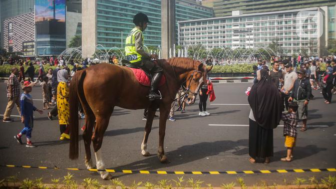 Polisi berkuda dari Direktorat Polisi Satwa Mabes Polri mengawasi keamanan di kawasan Bundaran HI, Jakarta, Minggu (17/11/2019). Polisi berkuda tersebut khusus ditugaskan mengawasi keamanan CFD serta memperkenalkan kepada warga. (Liputan6.com/Faizal Fanani)