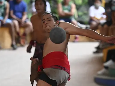 Seorang pria pribumi bermain selama final turnamen bola Maya di San Juan La Laguna, Solola, Guatemala, pada 18 September 2021. Sebanyak 12 tim, termasuk satu perempuan, berpartisipasi untuk mengklasifikasikan turnamen Mesoamerika yang akan diadakan di Meksiko pada Desember 2021. (Johan ORDONEZ/AFP)
