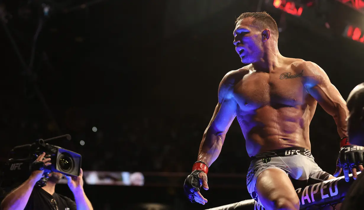 <p>Michael Chandler merayakan kemenangan KO atas Tony Ferguson (tidak terlihat) pada pertarungan kelas ringan putra UFC 274 di Footprint Center, Phoenix, Arizona, Amerika Serikat, 7 Mei 2022. Chandler dinyatakan menang KO atas Ferguson. (Christian Petersen/Getty Images/AFP)</p>