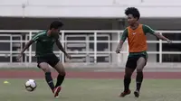 Pemain Timnas Indonesia U-19, Bagus Kahfi, berebut bola dengan Fadilah Nur Rahman saat latihan di Stadion Pakansari, Bogor, Rabu (2/10). Latihan ini merupakan persiapan jelang AFF U-19 di Vietnam. (Bola.com/Yoppy Renato)