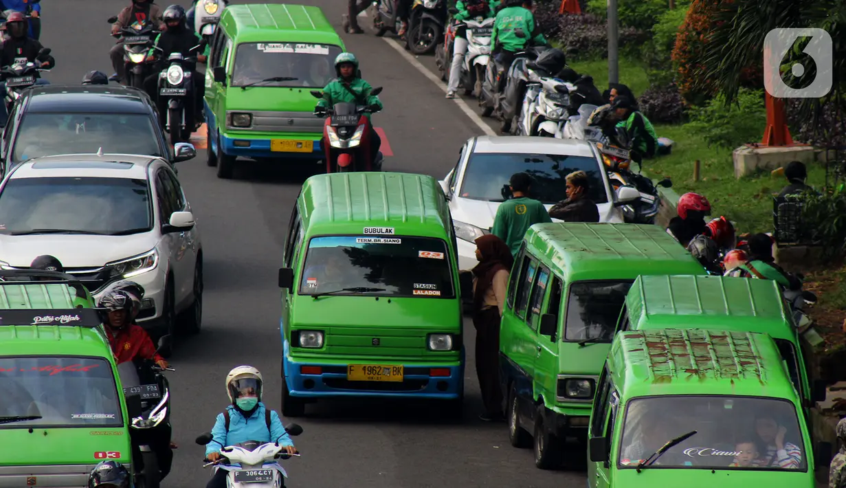 Sejumlah angkutan kota (angkot) berhenti di bahu jalan, Bogor, Jawa Barat, Selasa (28/1/2020). Masih banyaknya angkot yang menaikkan dan menurunkan penumpang tidak pada tempatnya mengakibatkan lalu lintas semrawut. (merdeka.com/Magang/Muhammad Fayyadh)