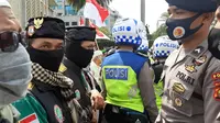Polisi membubarkan paksa massa Aksi 1812 yang terkonsentrasi di kawasan Patung Kuda, Jalan Medan Merdeka Barat, Jakarta Pusat. (Liputan6.com/Yopi Makdori)