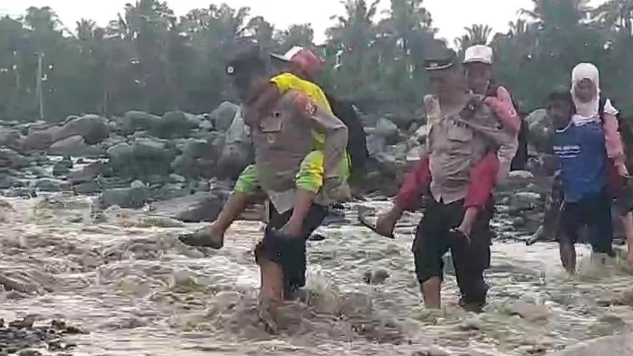 Momen Polisi Gendong Pelajar Lewati Sungai Lahar Semeru
