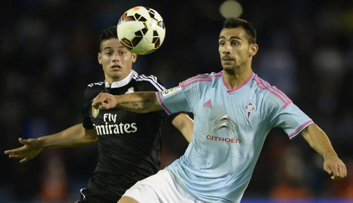 Bek Celta Vigo, Jonny Castro (kanan) berebut bola dengan penyerang Real Madrid James Rodriguez pada laga Liga Spanyol di Stadion Balaidos , Spanyol, Senin (27/4/2015). Real Madrid menang 4-2 atas Celta Vigo. (AFP PHOTO/Miguel Riopa)