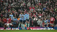 Gelandang Manchester United asal Portugal #08, Bruno Fernandes (Kanan), mencetak gol pembuka langsung dari tendangan bebas ini selama pertandingan Liga Primer Inggris antara Manchester United dan Arsenal di Old Trafford di Manchester, Inggris barat laut, pada 9 Maret 2025. (Paul ELLIS/AFP)
