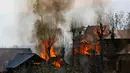 Sejumlah bangunan tempat tinggal terbakar akibat pertempuran senjata antara kelompok militan dan pasukan keamanan India di Shopian, Srinagar (4/1). Situasi wilayah ini kian memanas dan sering terjadi bentrokan. (AP Photo / Mukhtar Khan)