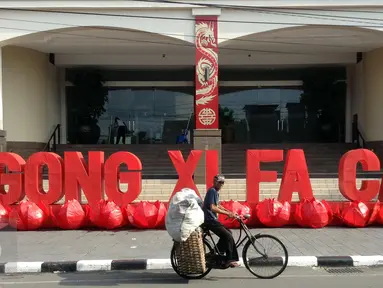 Pesepeda melintasi kawasan Ambarukmo Plaza,Yogyakarta yang di hiasi dengan Tulisan Gong Xi Fa Cai, Minggu (7/2).Aksesoris di pasang untuk menyambut tahun baru imlek sekaligus untuk menarik minat pembeli untuk berbelanja di mall tersebut.(Boy Harjanto)