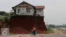 Warga melintas di samping Musala yang masih berdiri di lokasi pembangunan proyek Tol Cinere-Jagorawi di Depok, Jawa Barat, Selasa (1/11). Pembangunan Tol ini masih menyisakan 555 Bidang tanah yang belum dibebaskan. (Liputan6.com/Johan Tallo)
