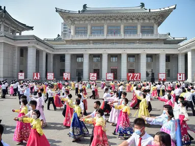 Para siswa ikut serta dalam 'pesta dansa' di luar Grand Theatre sebagai bagian dari acara yang menandai peringatan ke-68 berakhirnya Perang Korea atau disebut sebagai 'Hari Kemenangan dalam Perang Pembebasan Tanah Air Besar', di Pyongyang (27/7/2021). (AFP/STR/KCNA VIA KNS)