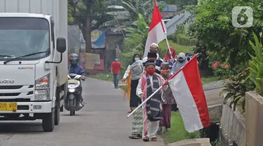 Sejumlah anak pengajian melakukan pawai di Jalan Raya Tapos, Depok, Jawa Barat, Kamis (22/10/2020). Pengajian Kampung Tapos menggelar pawai menyambut Hari Santri Nasional 2020 yang diperingati setiap tanggal 22 Oktober. (Liputan6.com/Herman Zakharia)