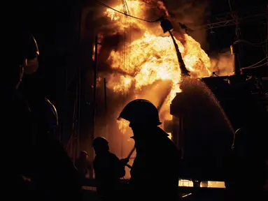 Petugas pemadam kebakaran Layanan Darurat Negara Ukraina memadamkan api setelah serangan roket Rusia menghantam pembangkit listrik di Kharkiv, Ukraina, Minggu (11/9/2022). Pemadaman total telah melanda wilayah Kharkiv  dan Donetsk karena serangan roket tersebut. (AP Photo/Kostiantyn Liberov)