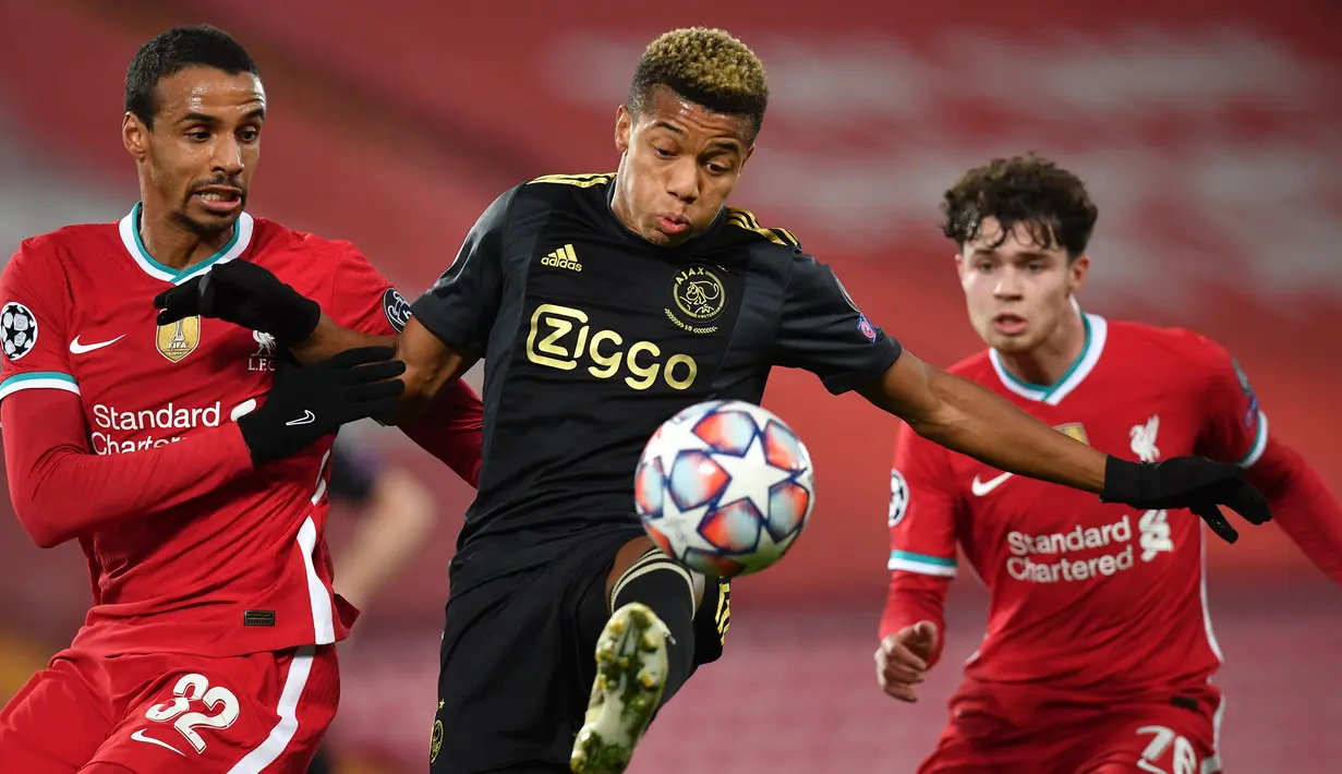 Striker Ajax Amsterdam, David Neres (tengah), mengontrol bola di antara dua pemain Liverpool, Joel Matip (kiri) dan Neco Williams dalam laga lanjutan Liga Champions 2020/21 Grup D di Anfield Stadium, Liverpool, Selasa (1/12/2020) waktu setempat. Ajax kalah 0-1 dari Liverpool. (AFP/Paul Ellis/Pool)