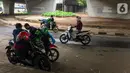 Pengendara motor beristirahat di jalur putar balik Jalan Gatot Soebroto, kawasan Kuningan, Jakarta, Selasa (12/11/2019). Jalur yang kini hanya bisa dilalui kendaraan roda dua itu menjadi lokasi sebagian pemotor beristirahat karena teduh tertutup jalan tol dalam kota. (Liputan6.com/Immanuel Antonius)